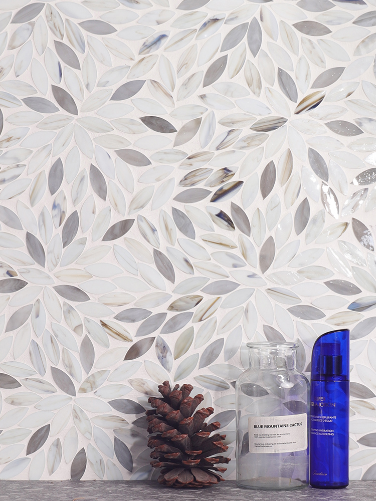 The floral glass mosaic backsplash brings a touch of elegance and artistry to the sink area, enhancing the space with its delicate and decorative design
