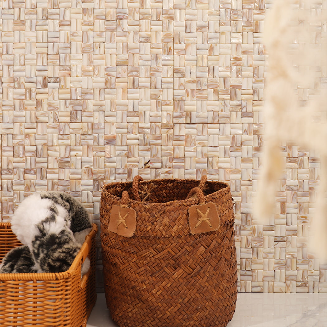 3D beige mother of pearl mosaic wall with natural baskets and decor.