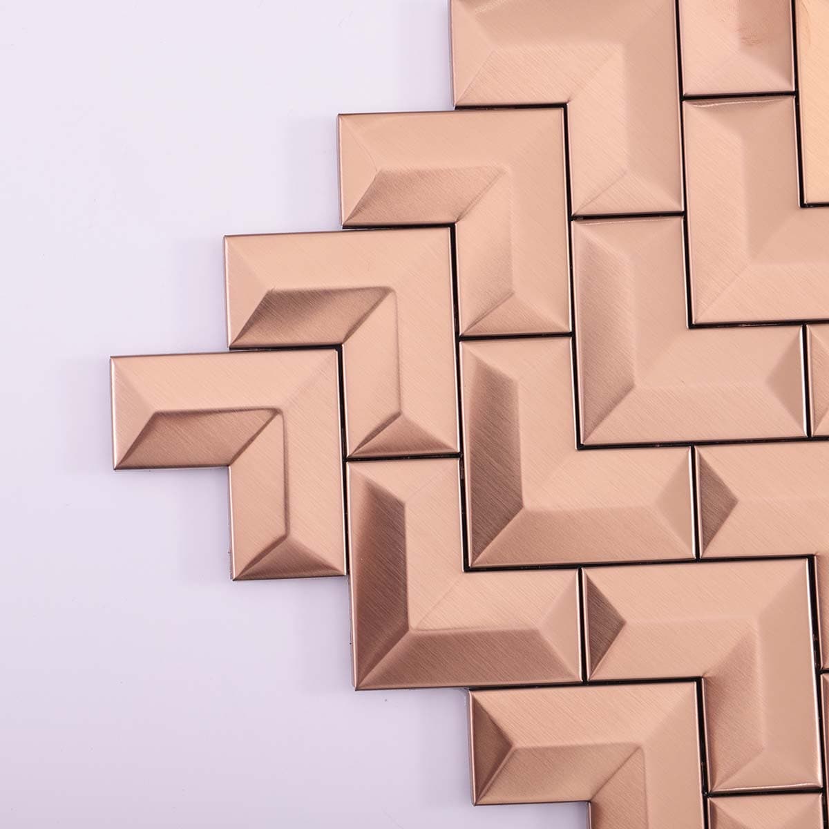  Corner detail of 3D brushed rose gold stainless steel chevron tile