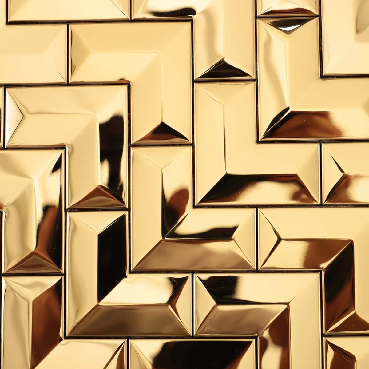 Angled view of gold 3D chevron mosaic tile surface