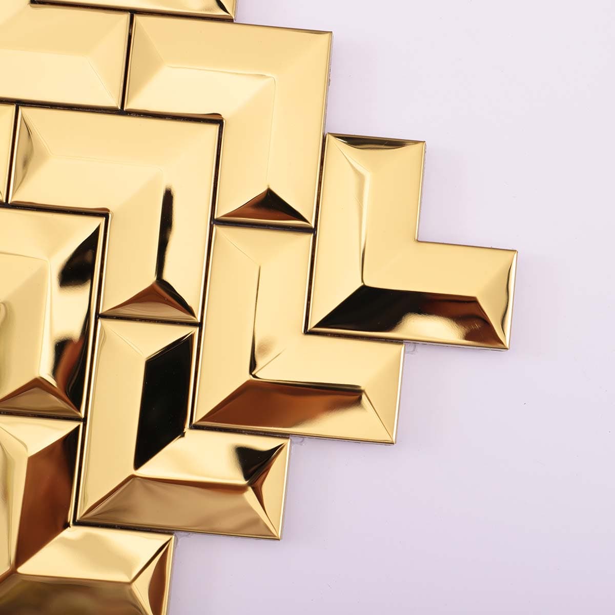 Close-up of corner edge on glossy gold chevron mosaic tile