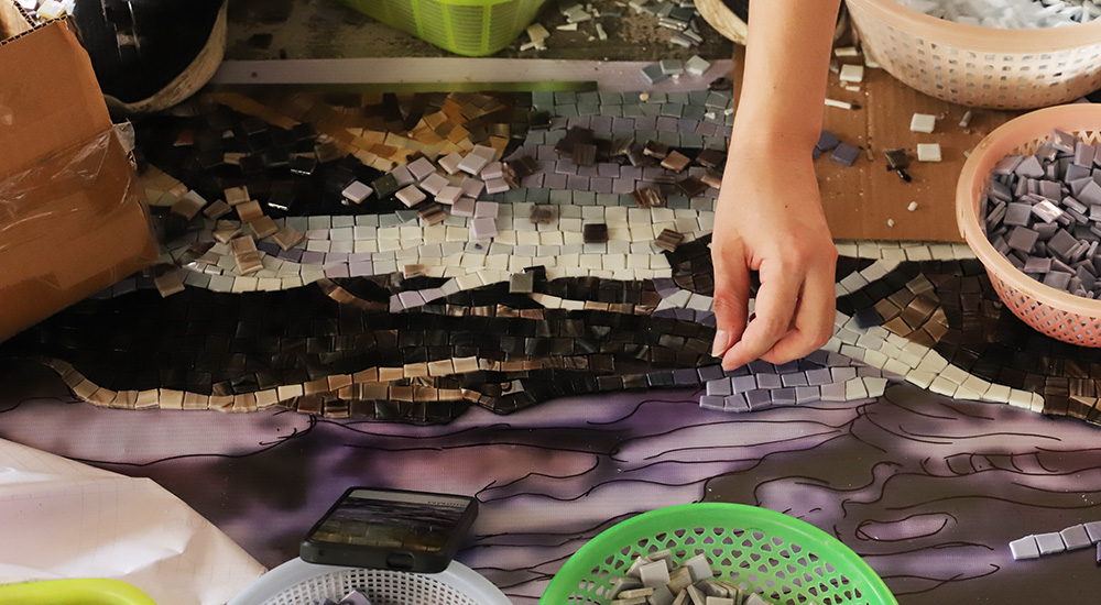 Mosaic tile mural in the process of being made.