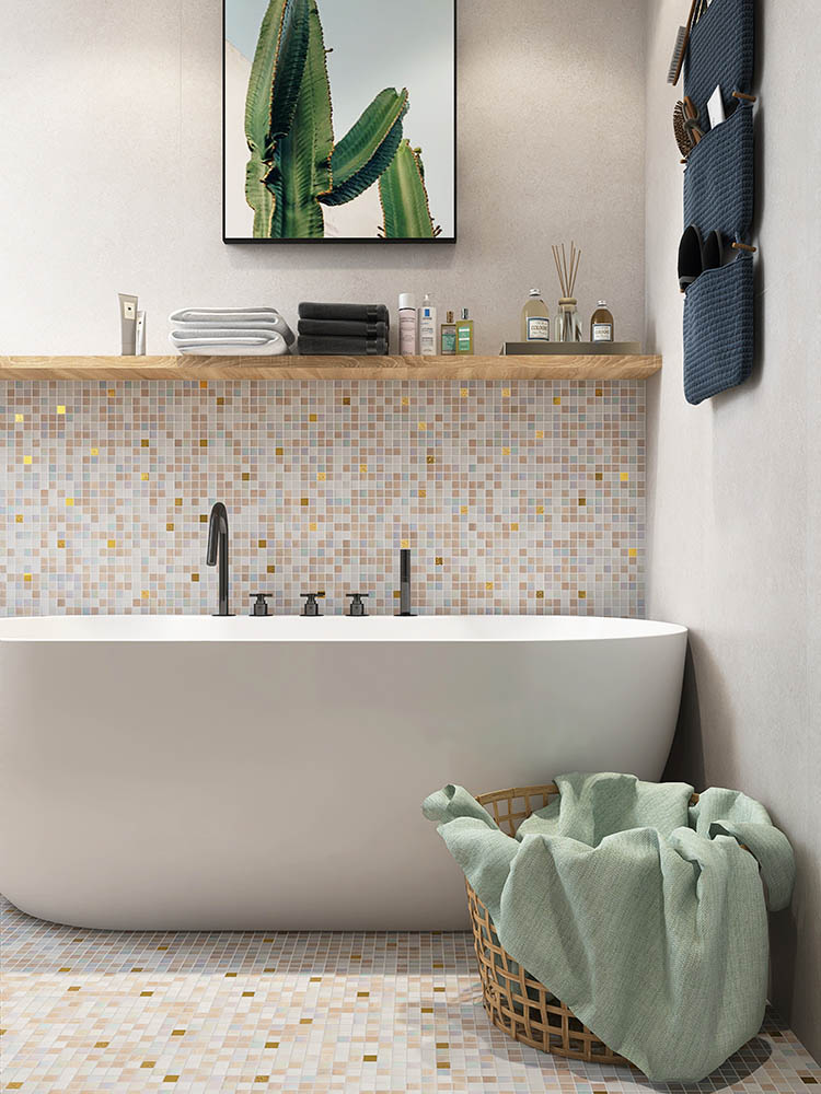 The beige and gold glass mosaic tiles add a warm, elegant shimmer to both the walls and floor of the bathroom
