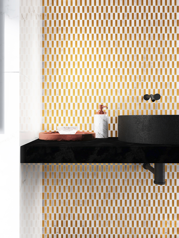 White marble combined with gold metal mosaic tiles on the bathroom wall brings a classic and luxurious feel, complemented by a sleek black sink.