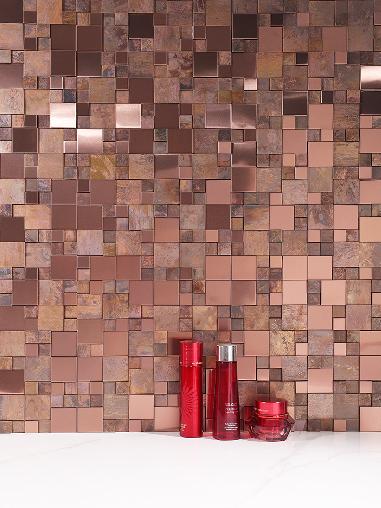 3D antique bronze metal mosaic backsplash behind the sink.
