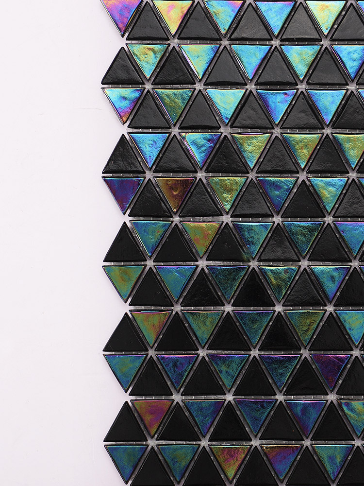 Close-up of black and iridescent triangular mosaic tiles in a checkboard pattern.