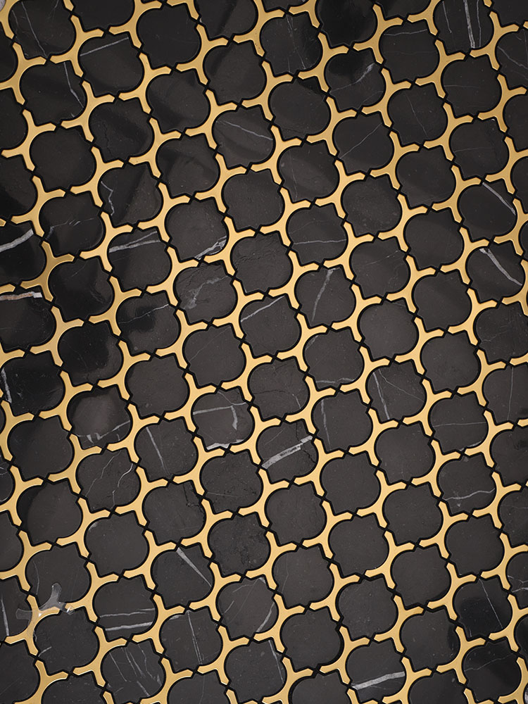 Black and gold arabesque marble mosaic tiles.