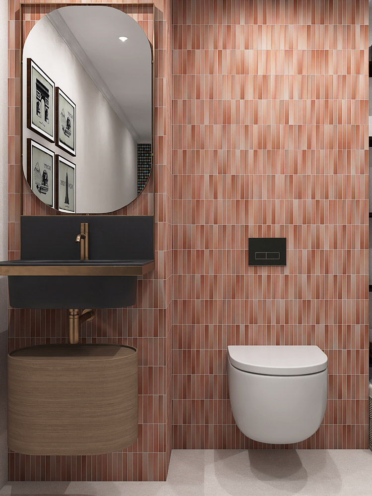 The peach-pink ceramic mosaic tiles bring a soft, warm hue to the bathroom walls, perfectly complementing the sink, mirror, and toilet for a harmonious design
