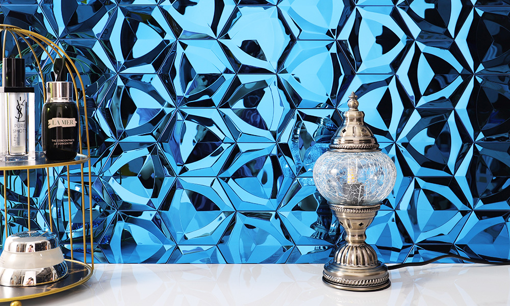 3D blue polished stainless steel hexagon mosaic tiles with a lamp in front.