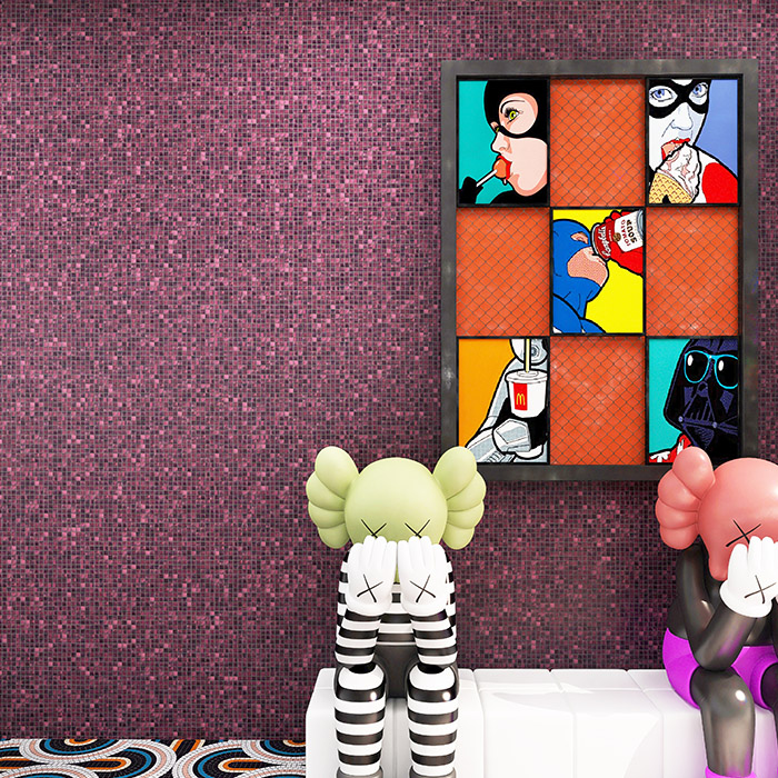 Purple glass mosaic tiles on the wall with a painting and a figurine