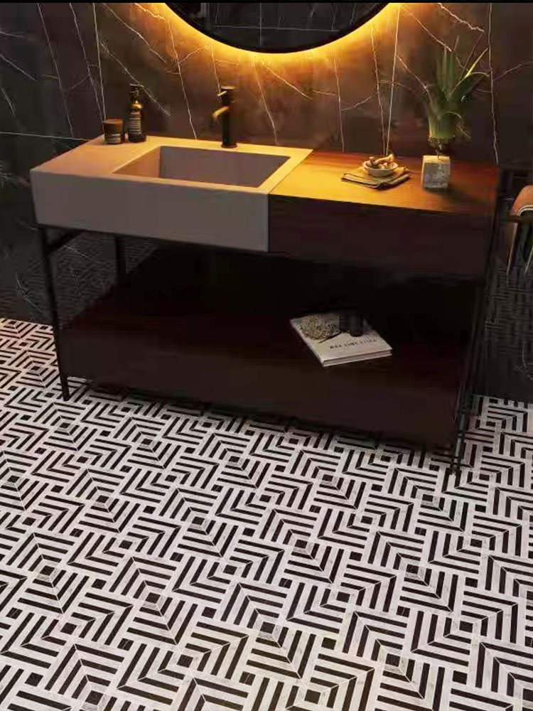 Black and white stone mosaic tiles on the bathroom floor with a vanity and mirror