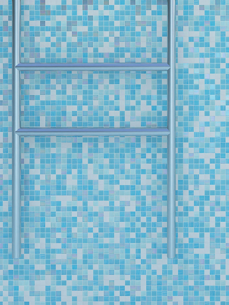 Blue and white mosaic tiles on the pool wall with a silver stainless steel ladder beside them.