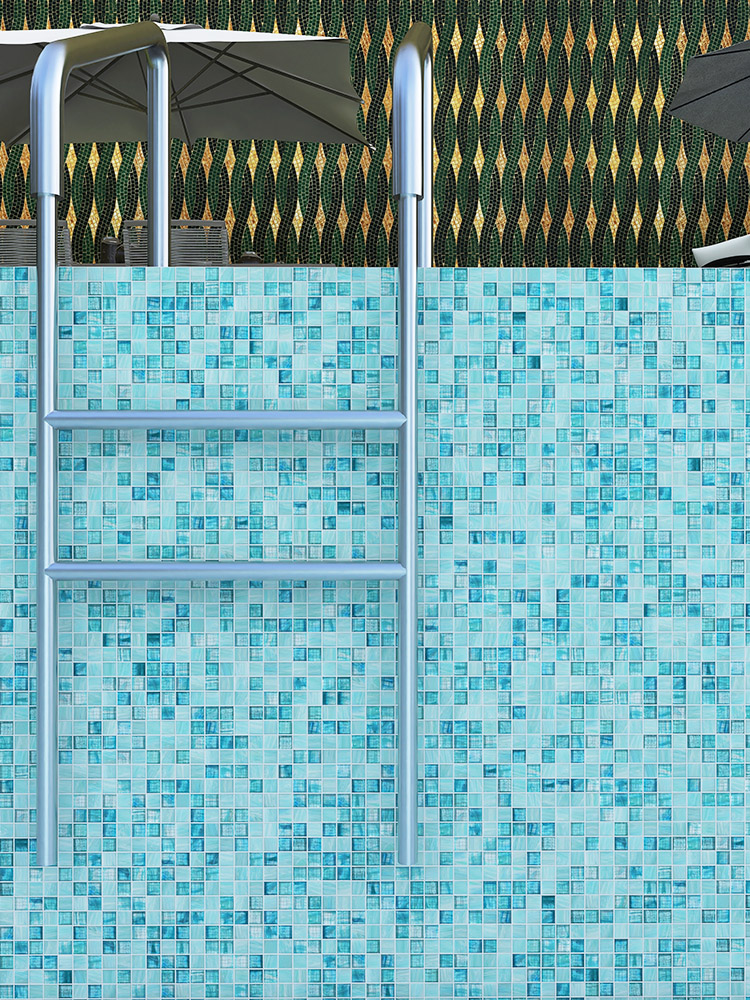 Blue-green mosaic tiles in the pool with decorative patterns visible by the poolside