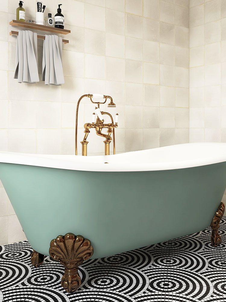 Black and white round mosaic tiles on the bathroom floor with off-white wall tiles and a bathtub