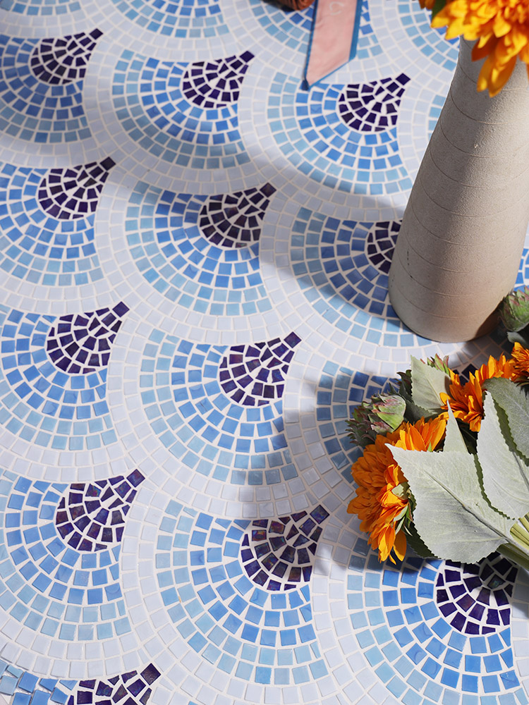 Blue fish scale handmade patterned mosaic tiles on the floor.