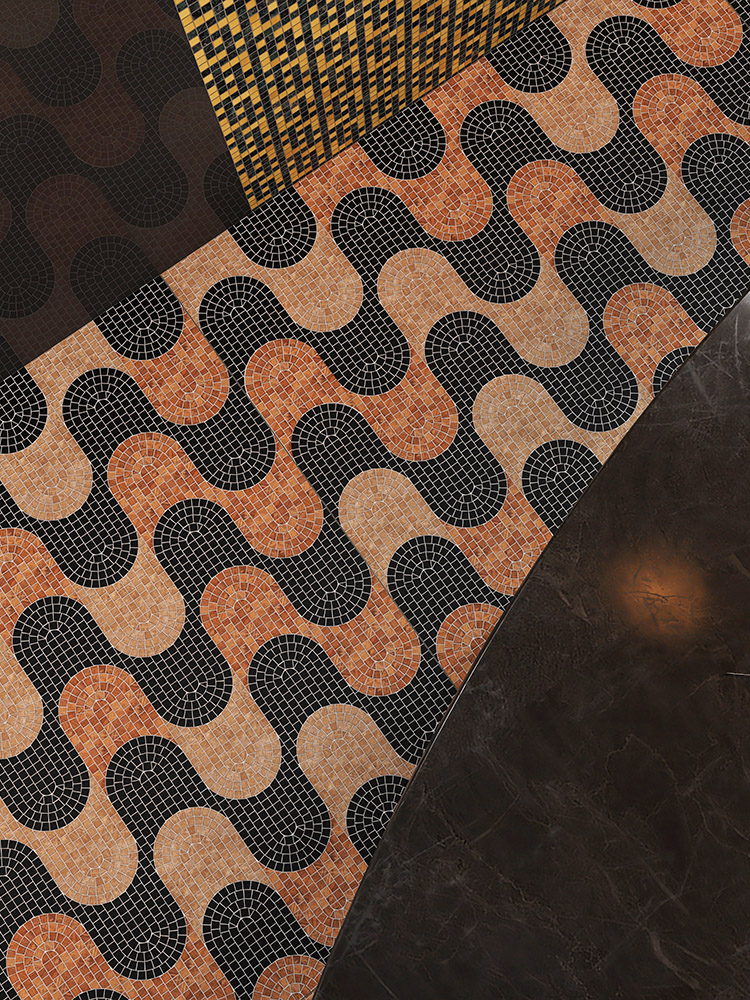 Marble mosaic tiles in a fish scale pattern, arranged to form a wave design.
