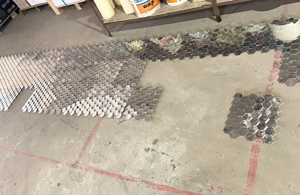 Metal crane sculptures in front of the backdrop