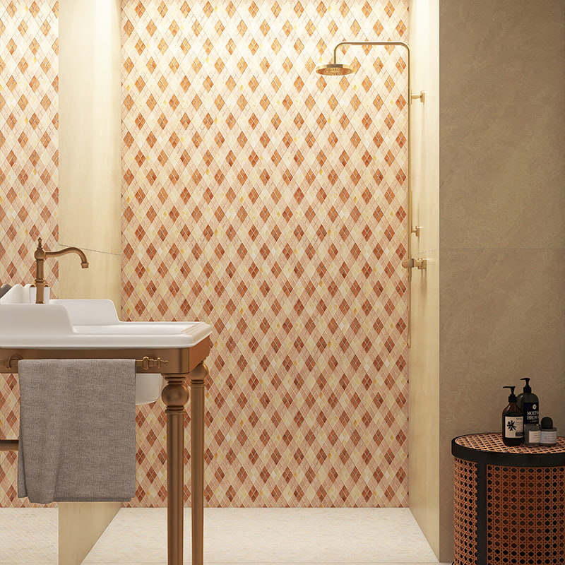 Beige and red diamond mosaic tiles on shower wall with brass fixtures