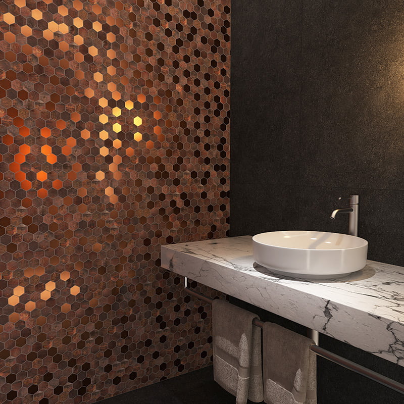 Copper hexagon mosaic tile wall behind marble countertop sink