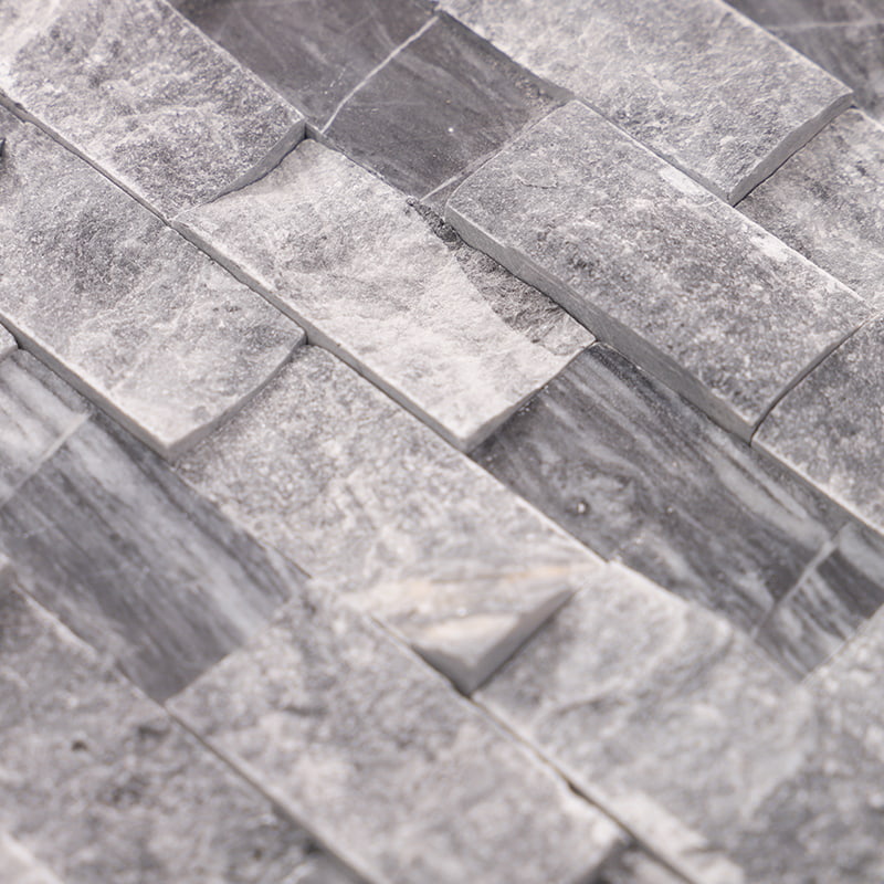 Close-up view of grey 3D marble relief mosaic tiles showing textured depth