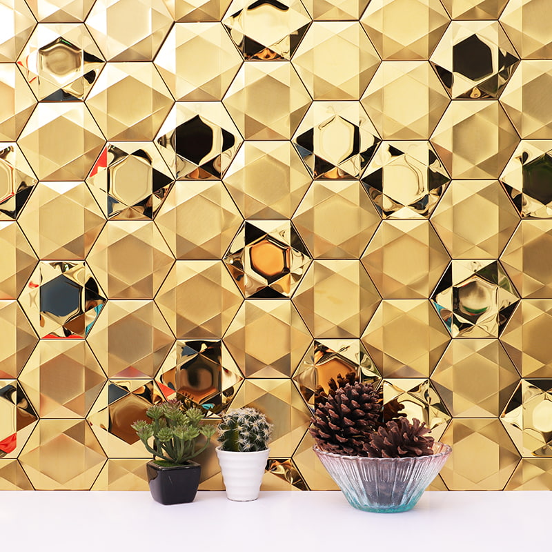 Reflective gold hexagon metal tiles with a polished surface effect. 