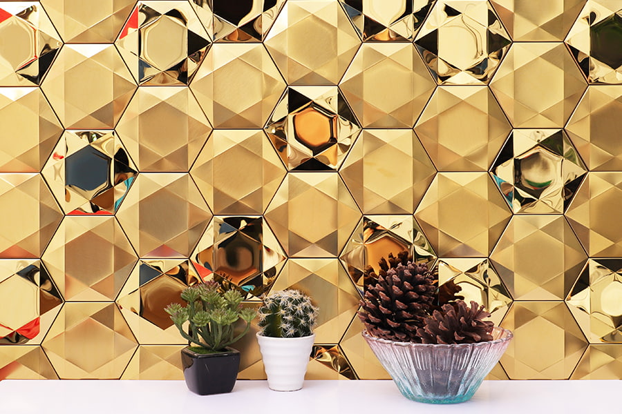 Glossy gold hexagon tiles with a 3D effect for a modern look.