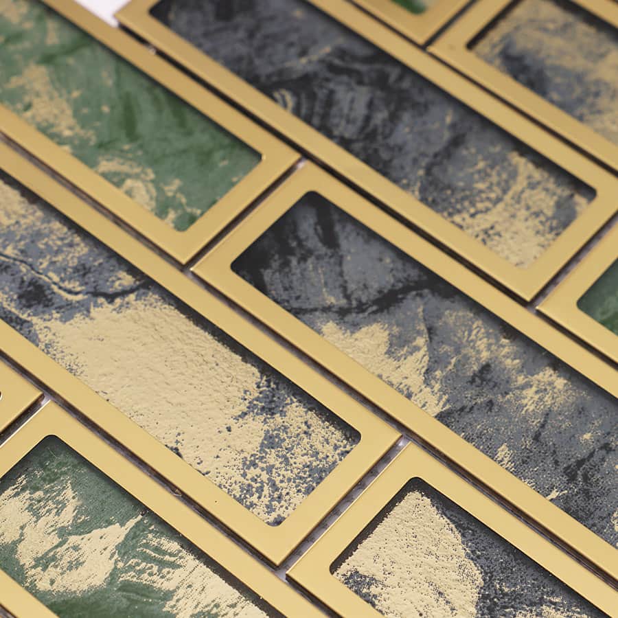 Detail view of mosaic with mixed foil textures and gold stainless frames.