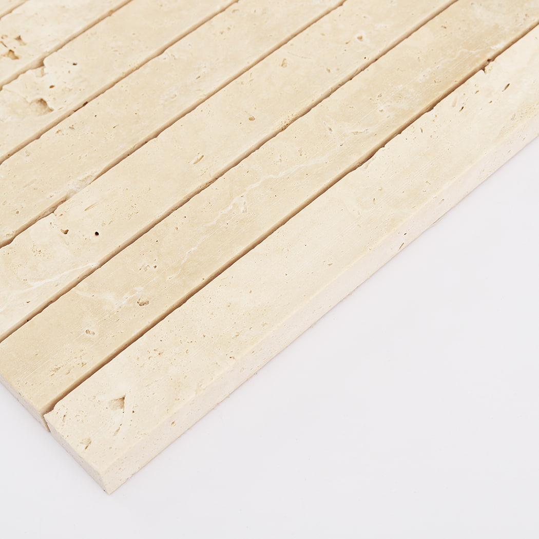 Side angle view highlighting the raised fluted profile of travertine mosaic tiles.