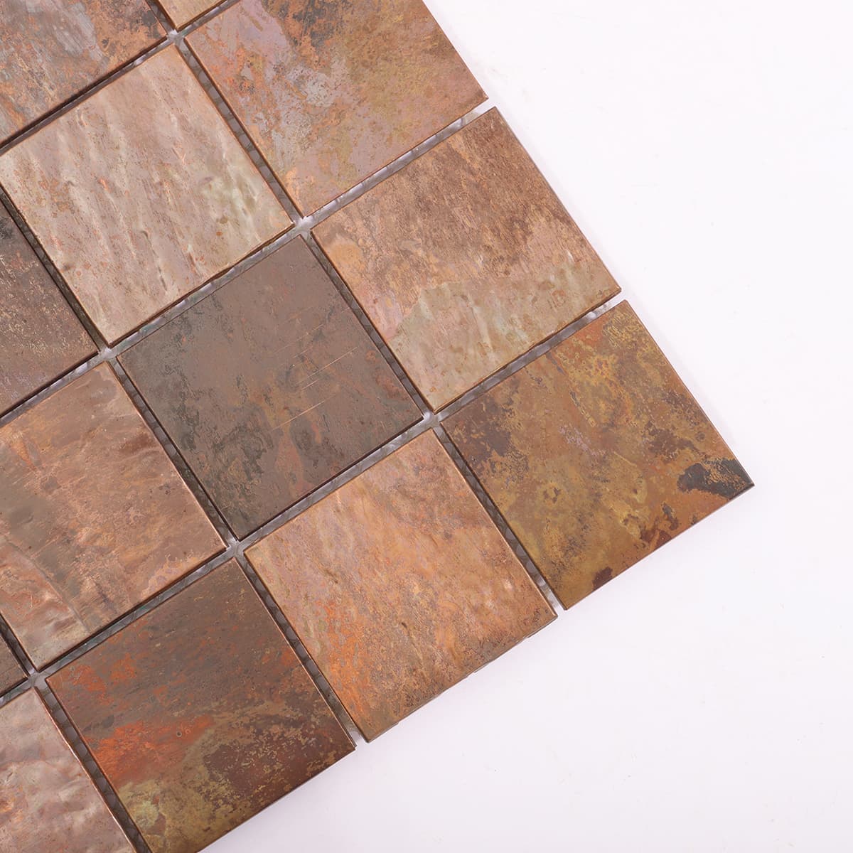 Corner angled view of brushed antique copper mosaic tiles