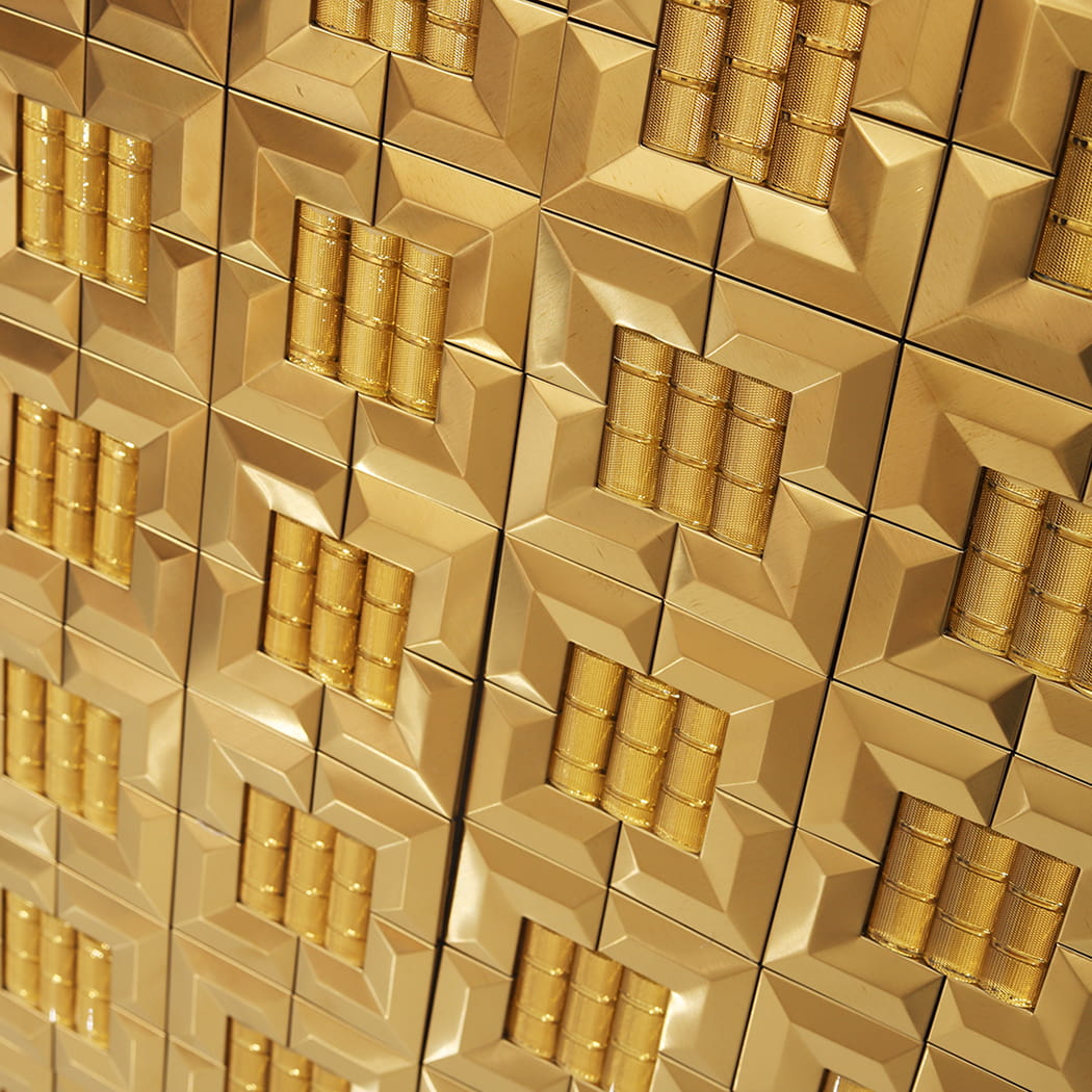 Close-up angled view of a gold 3D mosaic wall installation with shimmering highlights.