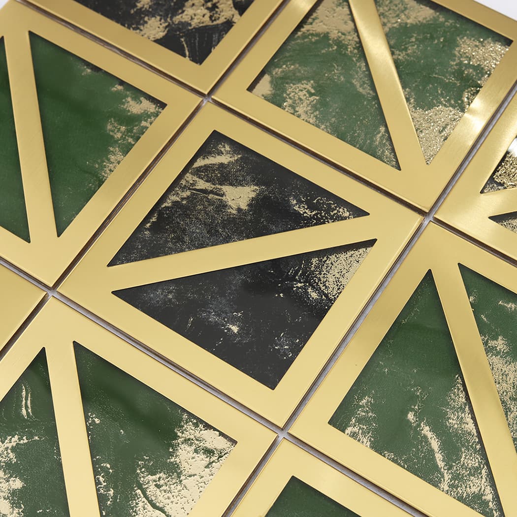Angled view showing the reflective gold frames and dark green marble tile texture.