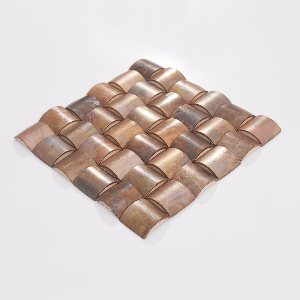 Angled view of antique copper 3D square metal mosaic tile sheet with curved pieces