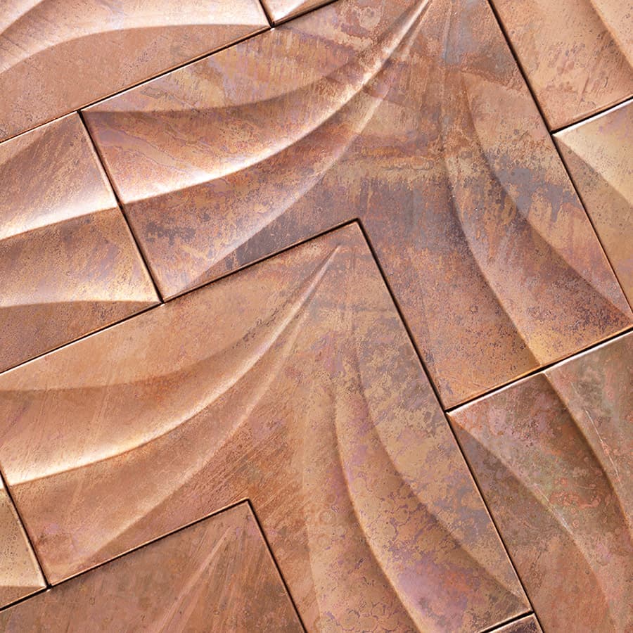 Close-up showing texture and leaf pattern of antique copper mosaic tile.