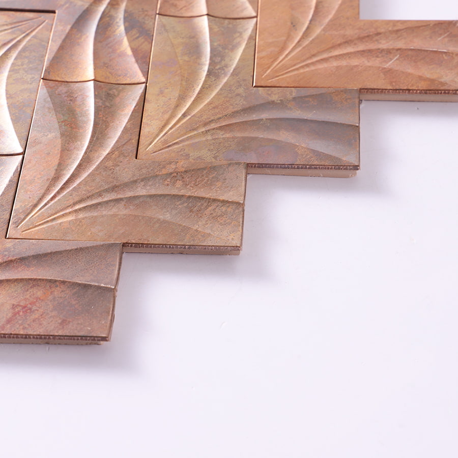 Edge detail of antique copper leaf pattern metal mosaic tile.
