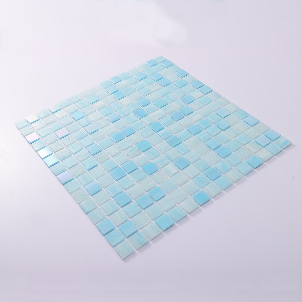 Angled view of aqua blue square glass mosaic sheet laid flat