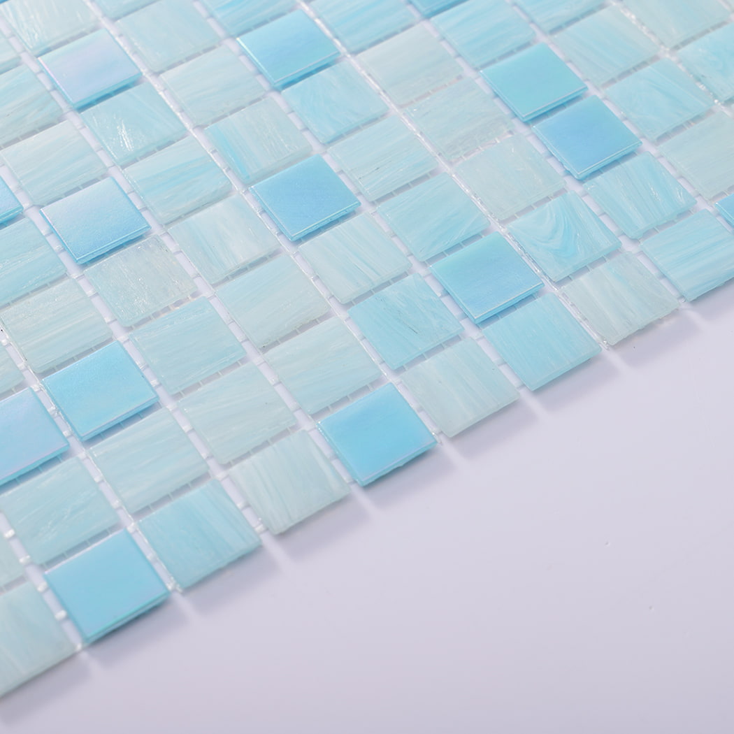 Edge detail showing surface texture of aqua blue square glass mosaic tiles