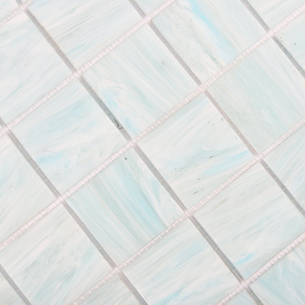 Angled detail of aqua blue glass mosaic tile pattern with square pieces and spacing