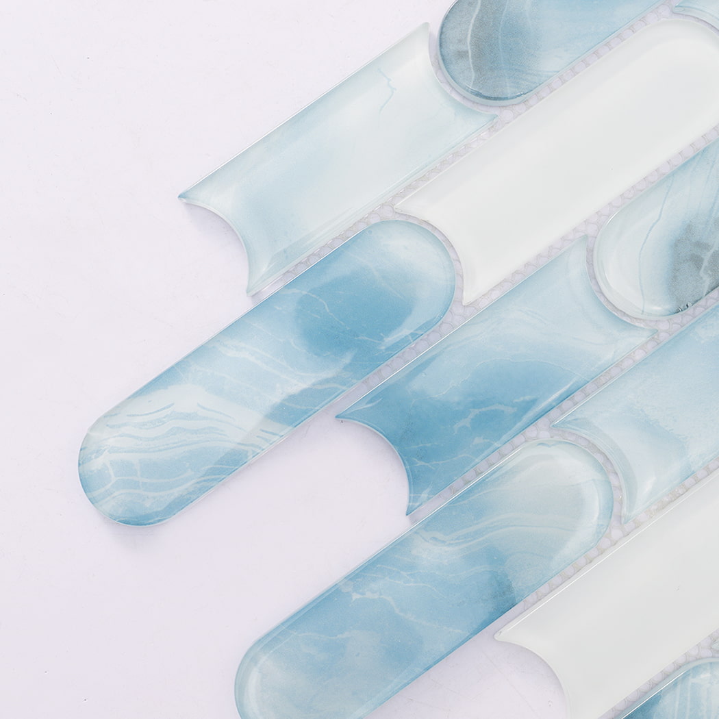 Close up of aqua blue patterned and white capsule glass mosaic tiles