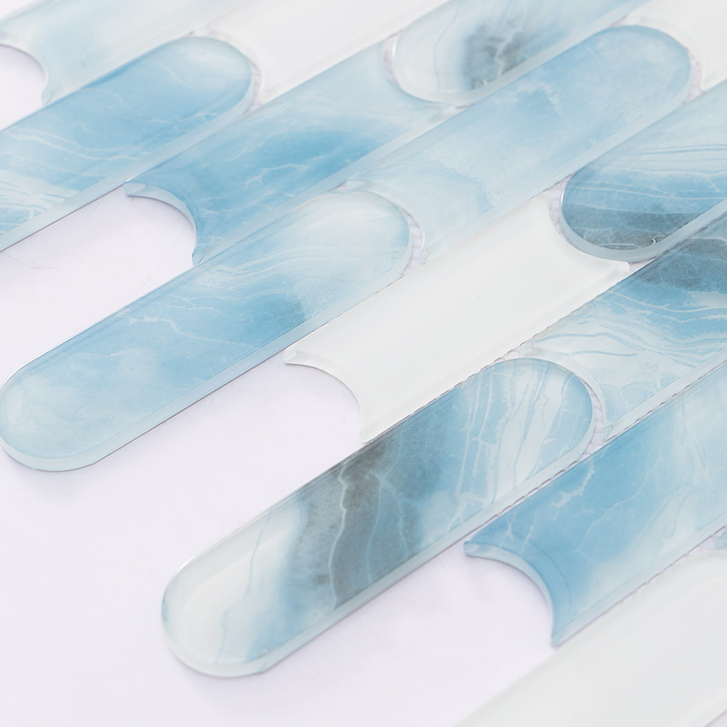 Detailed view of aqua blue and white capsule glass mosaic tile pattern