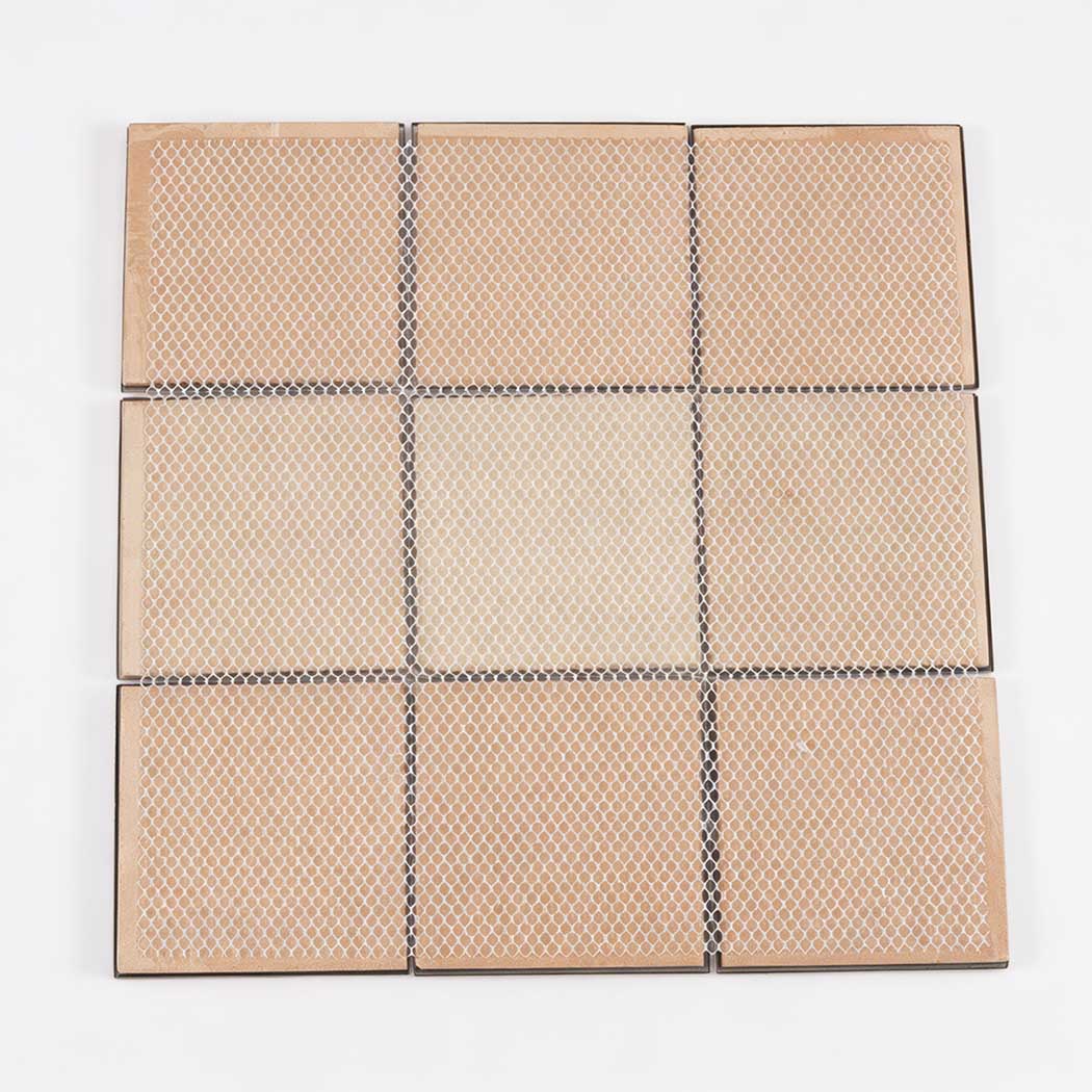 Back view of black and gold square metal mosaic tile sheet with mesh backing