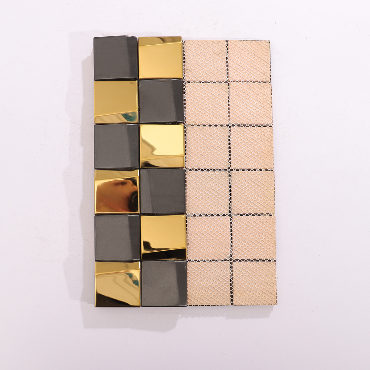 Rear view of gold and black stainless steel mosaic tiles, showing the backing structure.