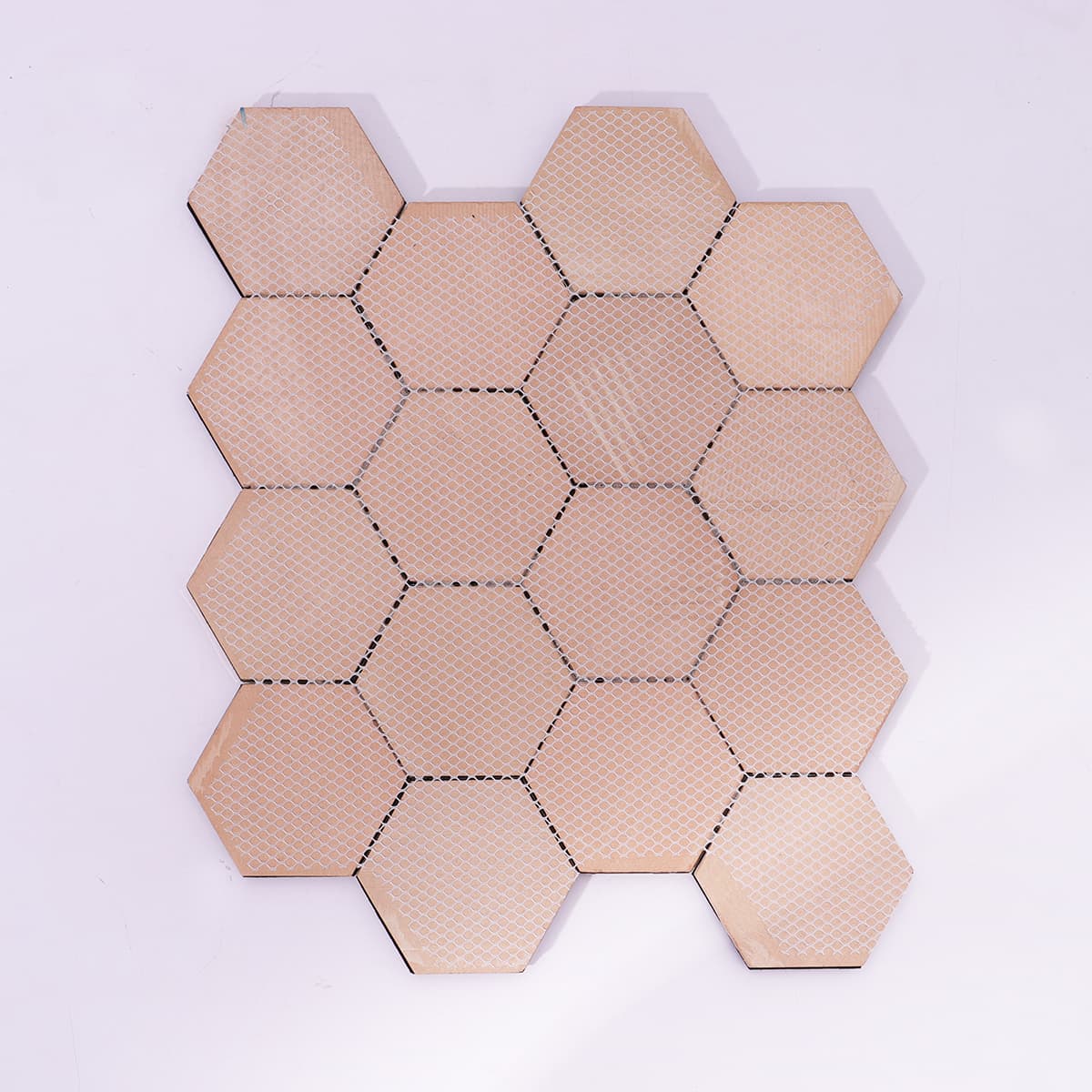 Rear mesh backing of geometric hexagon tile sheet.