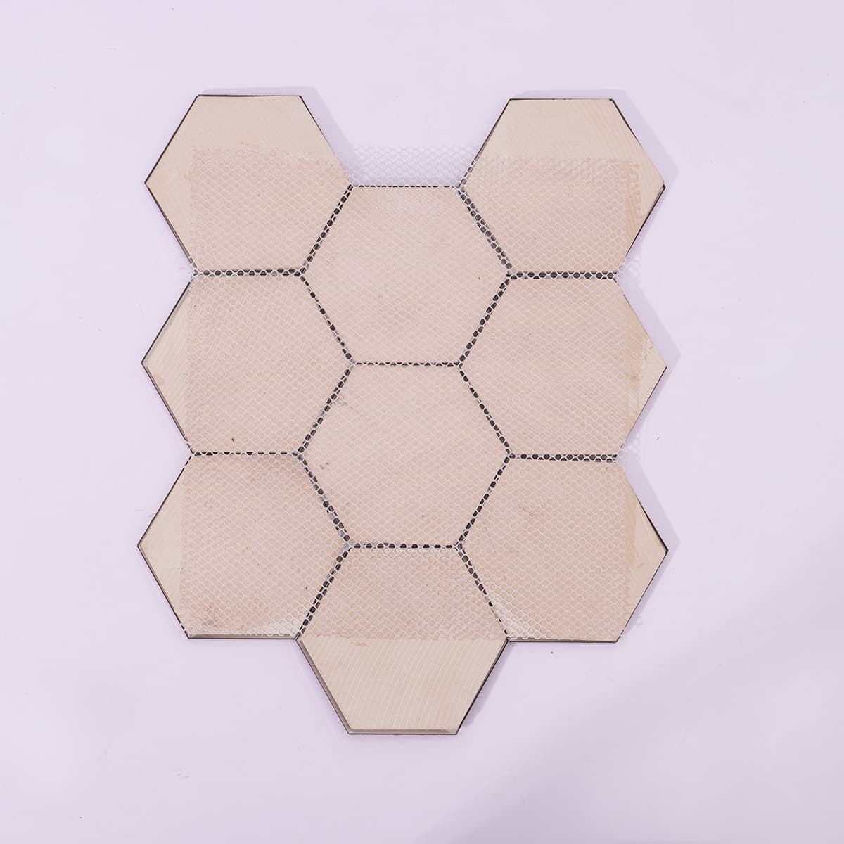 Back side of pink hexagonal mirror mosaic tile with mesh backing
