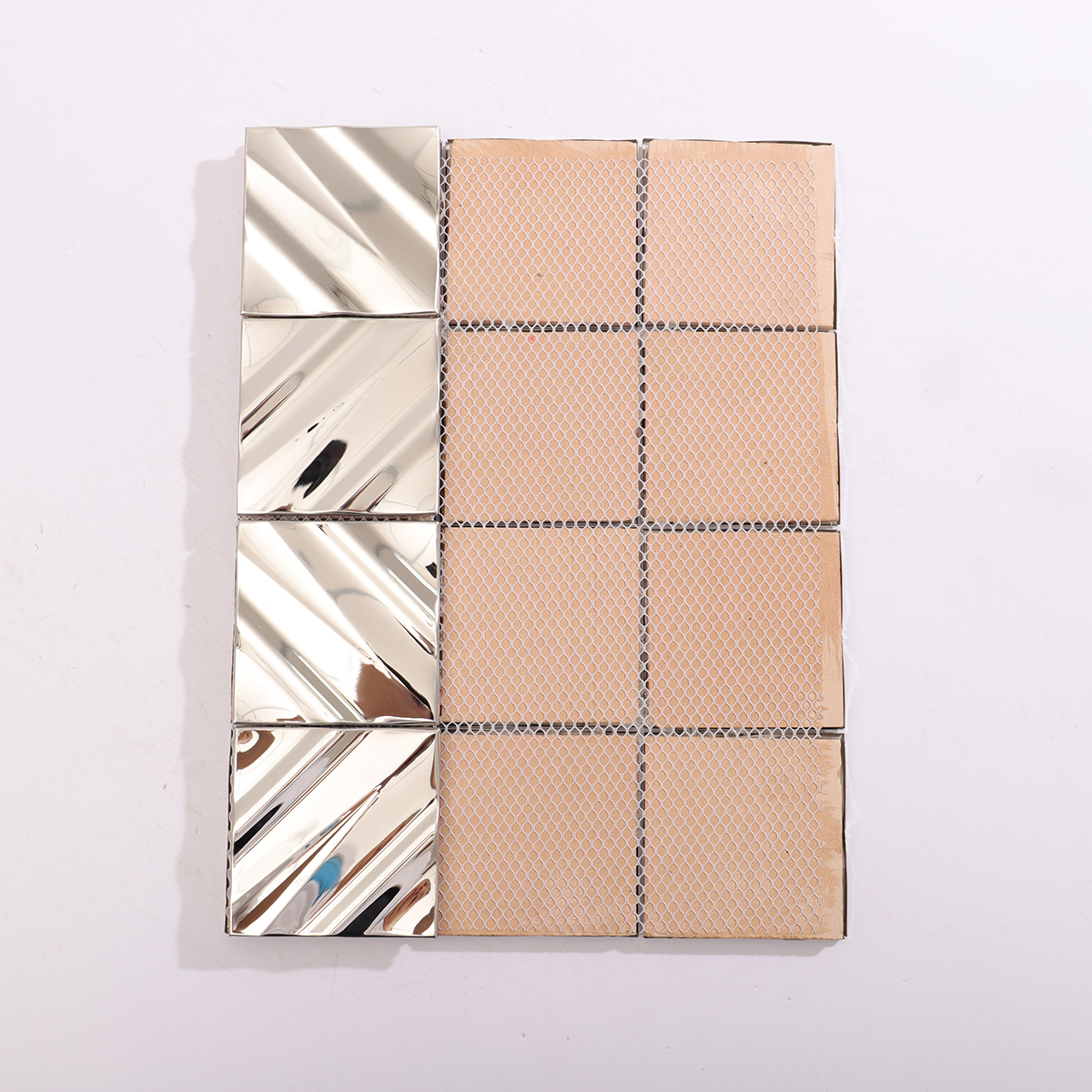 Backside of the glossy silver metal mosaic tiles, showing support structure.