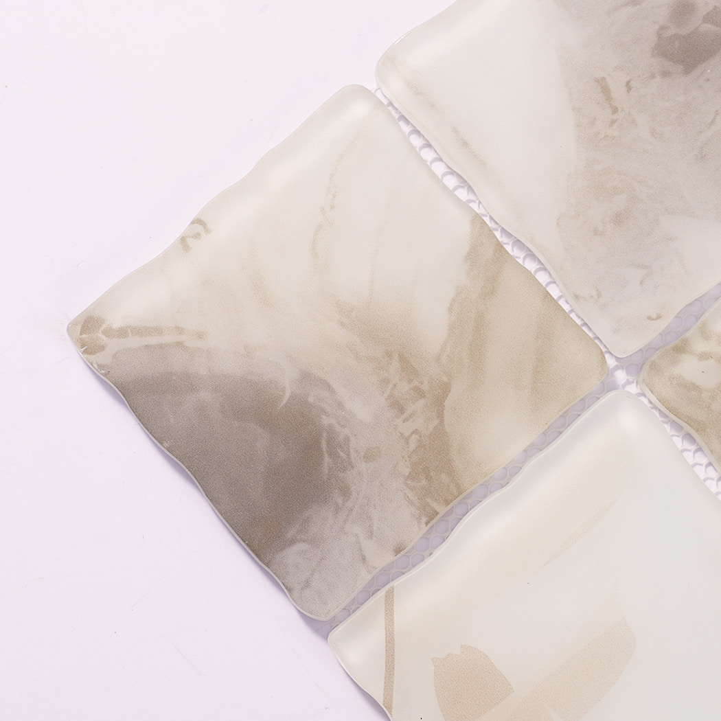 Close-up of beige cream wavy square glass mosaic tiles with cloudy texture