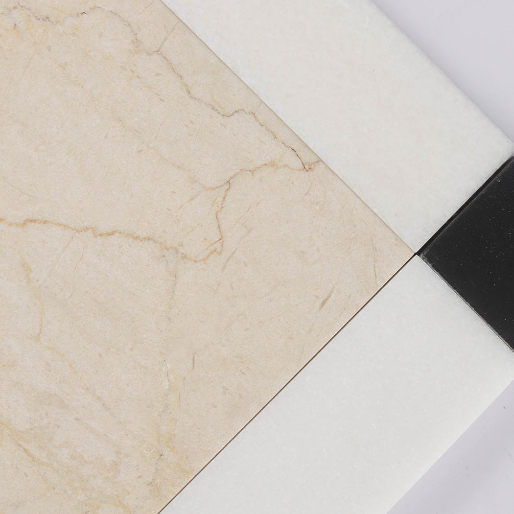 Beige marble center tile with natural veining and white marble border