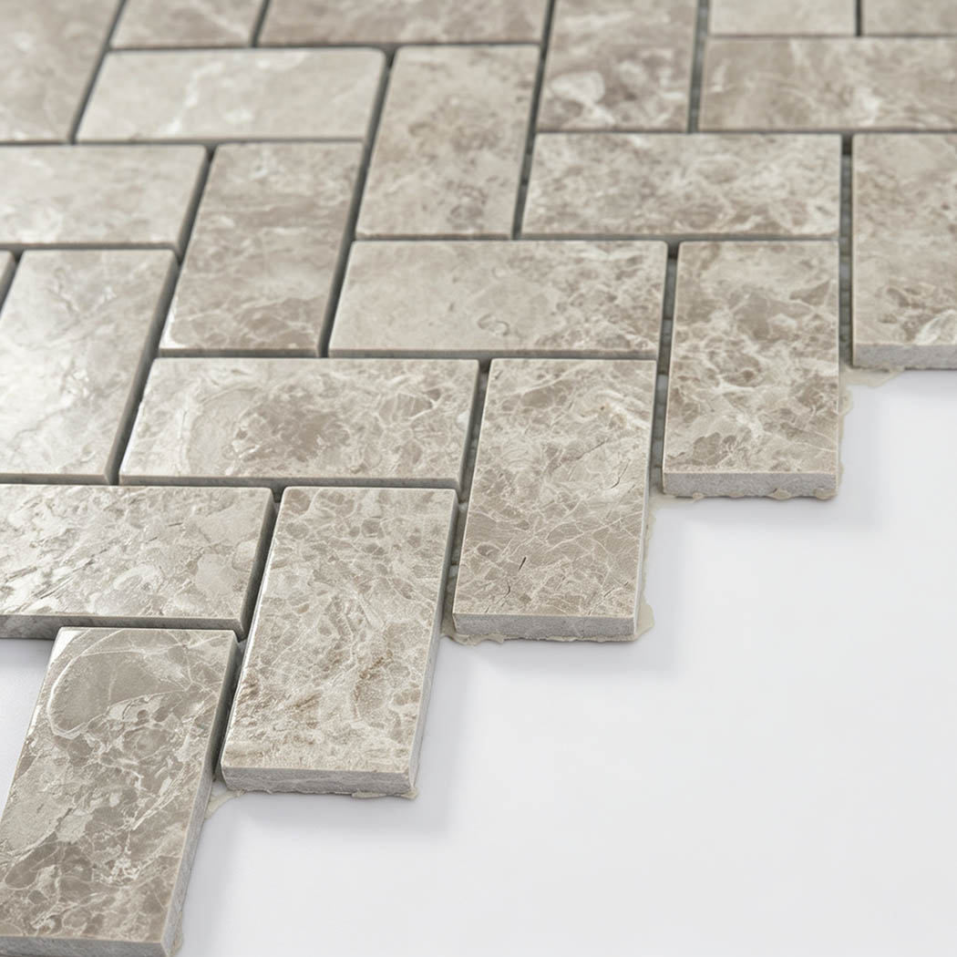 Side view of beige marble herringbone mosaic tiles