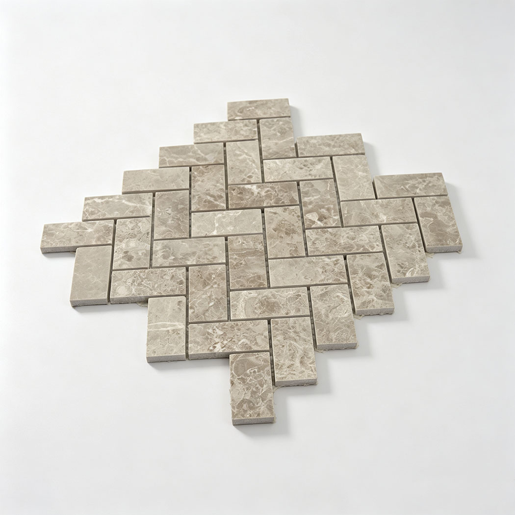 Beige marble herringbone mosaic tile sample with an interlocking layout