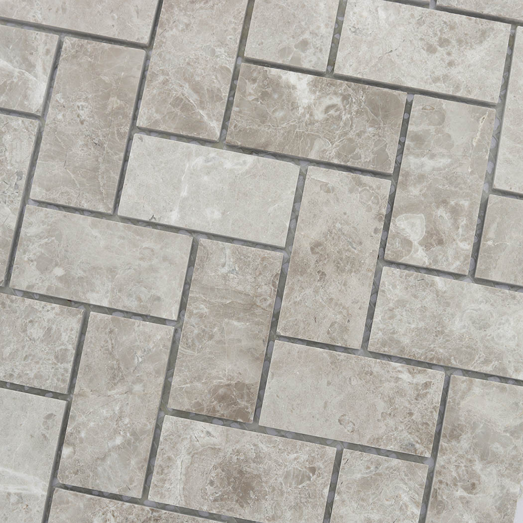 Beige marble herringbone mosaic tile detail with soft natural veining