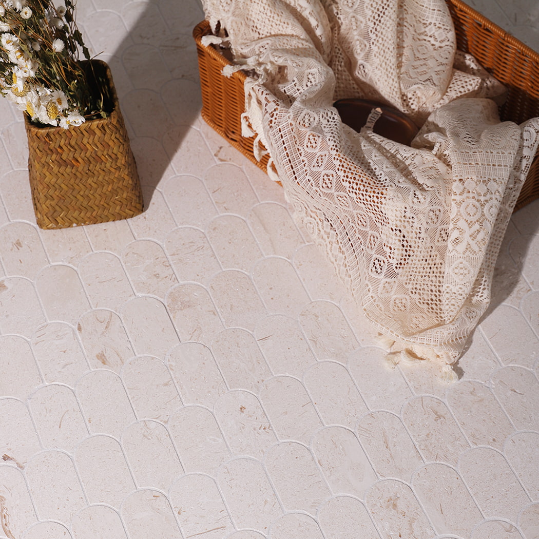 Close up of beige marble mosaic floor showing natural texture